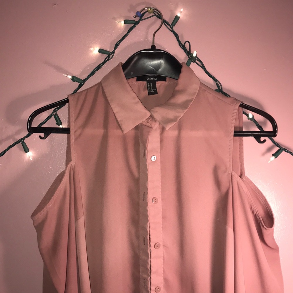 A nude colored cold shoulder long-sleeve top